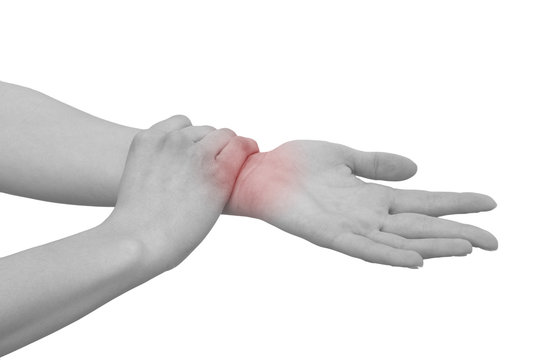 Acute pain in a woman wrist. Female holding hand to spot of wris