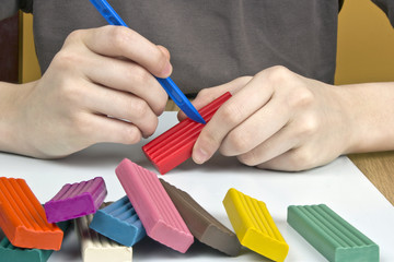 Boy moulds from plasticine