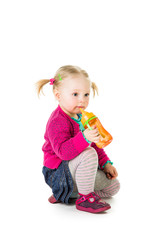 Baby girl drinking tea from bottle