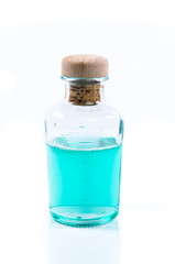 Obraz na płótnie Canvas Glass bottle of turquoise blue liquid