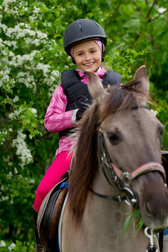 Horse riding - lovely girl is riding on a horse