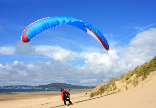 paraglider landing on beach