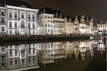 Reflections of white buildings in a canal in Ghent