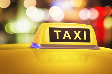 Yellow taxi sign on car