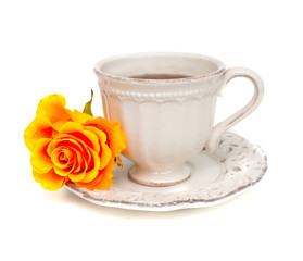 orange rose and white cup