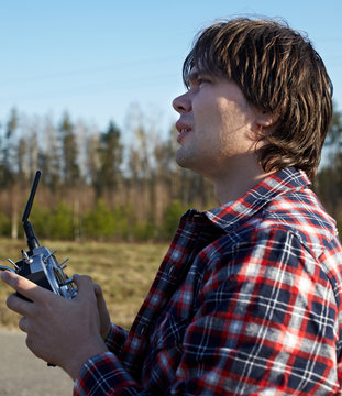 Young man controls RC plane in the sky