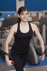 Fototapeta na wymiar Beautiful fit woman at the gym smiling