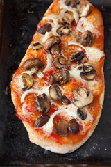 unusual pizza with mushrooms and tomato sauce