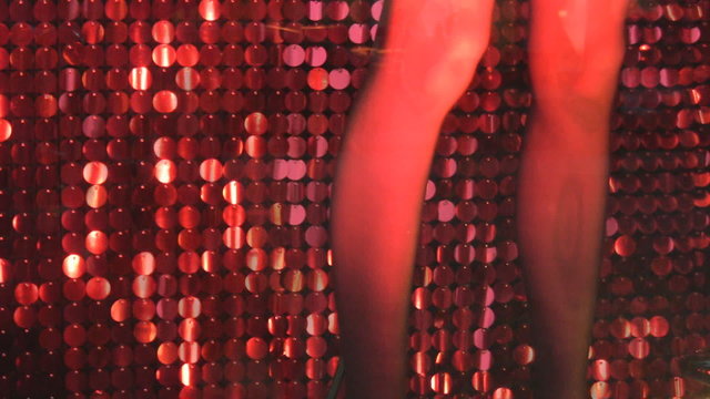 Mannequin&rsquo;s legs in a storefront window. Red legs.