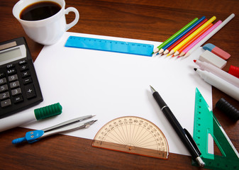Desk with sheet of paper and stationery objects