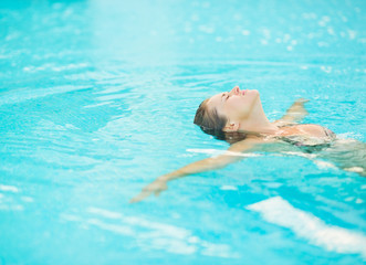 Young woman swimming in pool