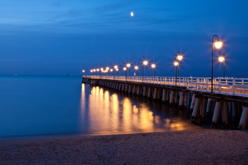 Fototapeta na wymiar Sunrise on the pier at the seaside, Gdynia Orlowo, Poland.