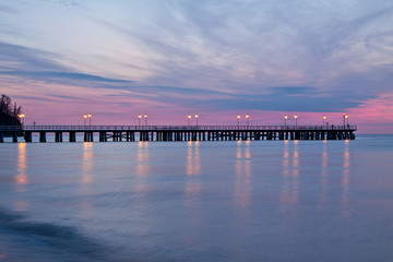 Fototapeta na wymiar Sunrise on the pier at the seaside, Gdynia Orlowo, Poland.