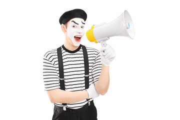 A male mime artist holding a loudspeaker and looking at camera