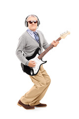 Full length portrait of a mature man with glasses playing guitar