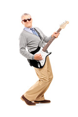 Full length portrait of a smiling mature man playing guitar