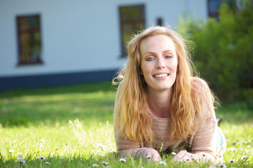 Beautiful lady lying on grass outdoors