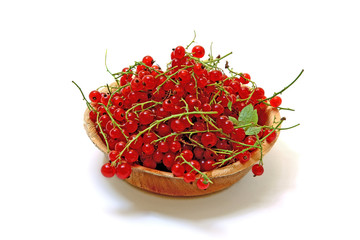 Fototapeta premium Red currants in the plate isolated on white