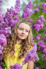 Spring portrait of a beautiful girl with lilac