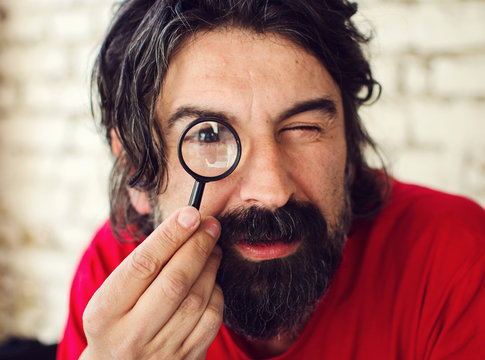 Attractive Man with Magnifying Glass