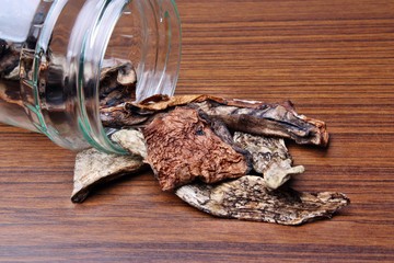 Muschrooms dried leccinum versipelle in a jar on the table
