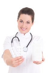 young attractive female doctor giving pills over white