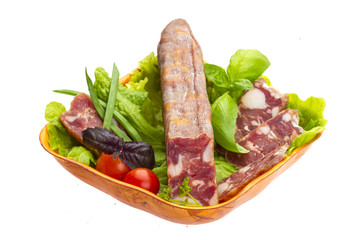 Ripe salami with salad, basil, onion and tomato