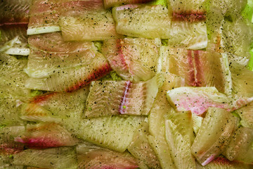 Spoiled raw green fish on a tray