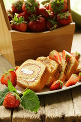 roulade cake with cream and strawberries © Olga Kriger