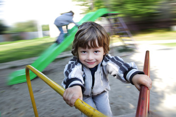 happy boy on carousel outdoors