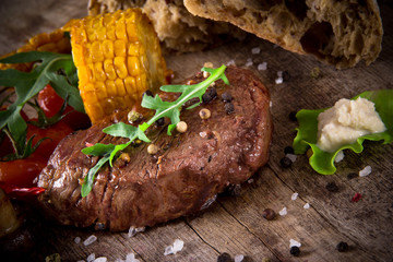 Delicious beef steak on wooden table