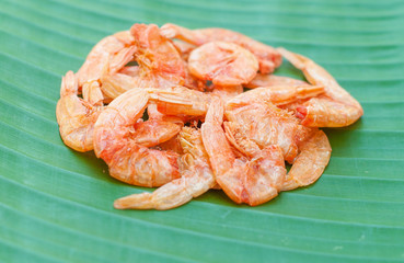 Dried shrimp on green leaf background