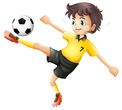 A boy kicking the soccer ball