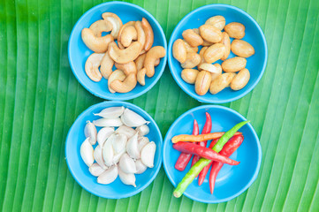 Red chilli garlic and bean on green leaf