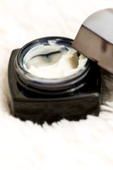 Fototapeta na wymiar Cosmetic cream in jar close up shallow DOF