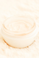 Obraz na płótnie Canvas Cosmetic cream in jar close up shallow DOF