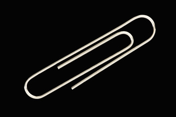 Obraz premium Single paperclip, black background