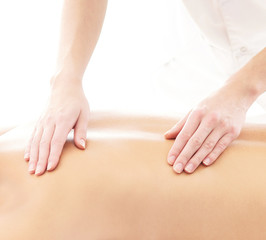Fototapeta premium Young attractive woman getting massaging treatment over white ba