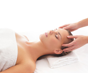 Obraz na płótnie Canvas Young attractive woman getting massaging treatment