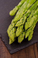 Grüner Spargel auf schwarzem Schiefer