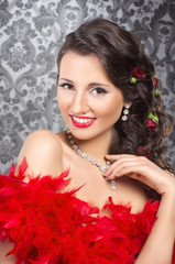 Cabaret artist in red boa over the vintage background