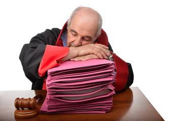Exhausted senior adult judge sleeping on stack of law files