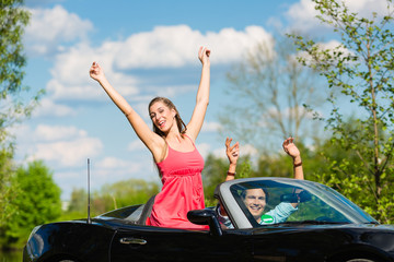 Young couple with cabriolet in summer on day trip