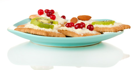 Tasty canapes with cheese, kiwi and cranberry, almond,