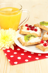 Tasty canapes with cheese and kiwi, cranberry,