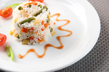 Delicious risotto with vegetables on table