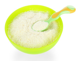 Powdered milk in bowl and spoon for baby isolated on white