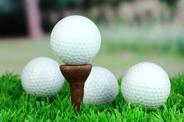 Golf balls on grass outdoor close up
