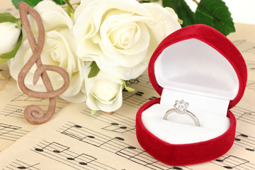 Treble clef, roses and box holding wedding ring