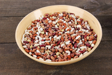 Beans in bowl on wooden background